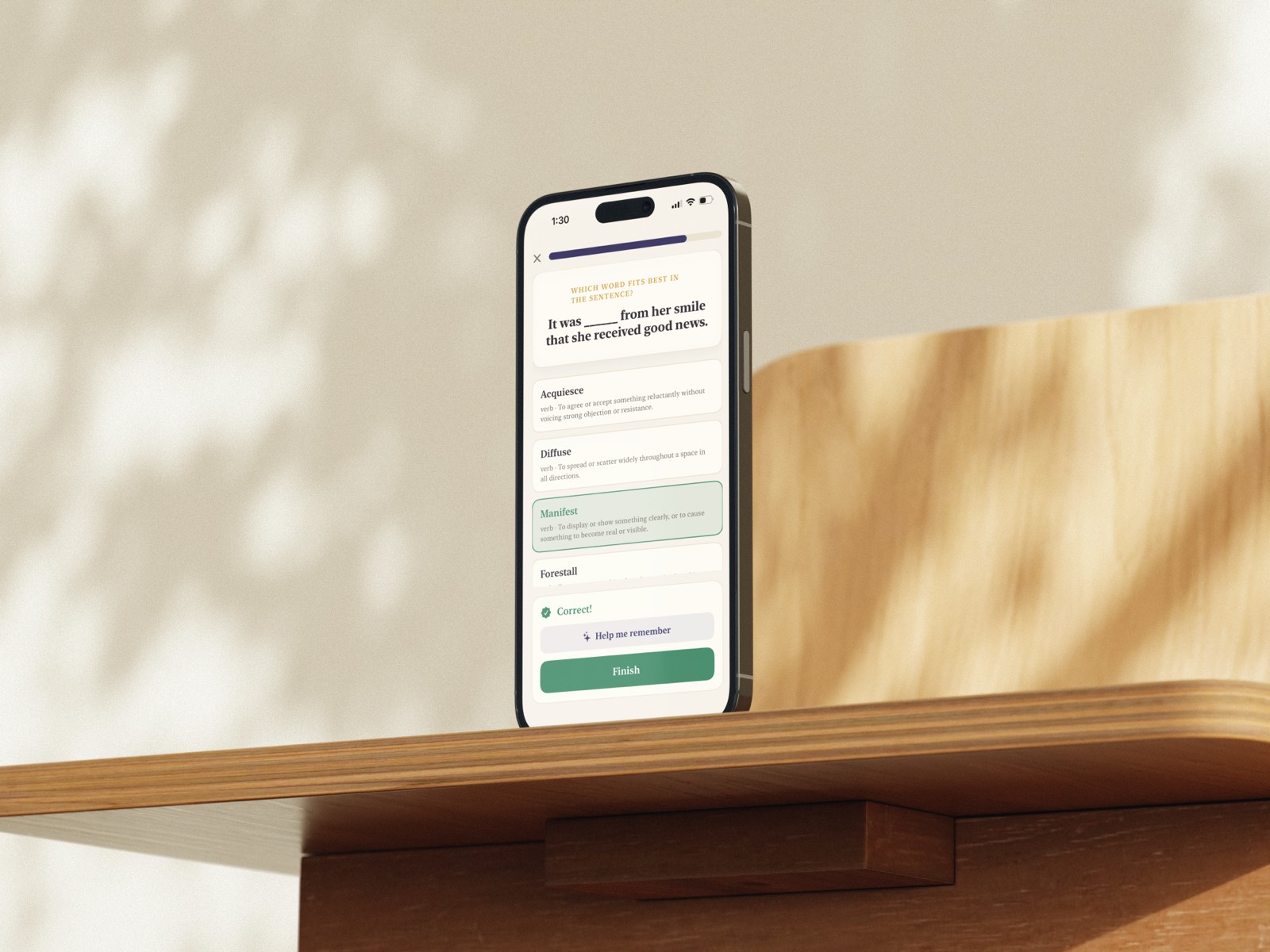 Vocabeelary on an iPhone on a sunlit wooden desk, a sentence question answered correctly with Manifest